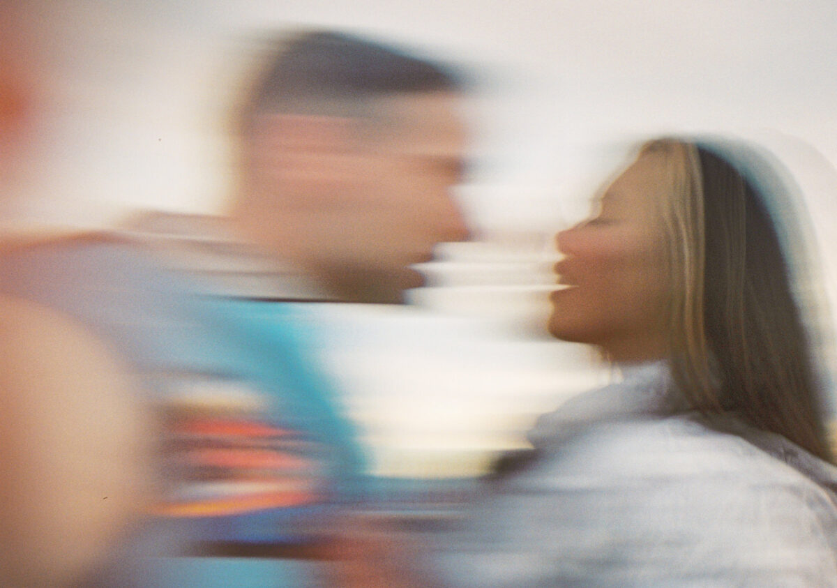 A motion blur picture taken of a couple coming towards each other about to kiss taken with film photography in victoria bc. 