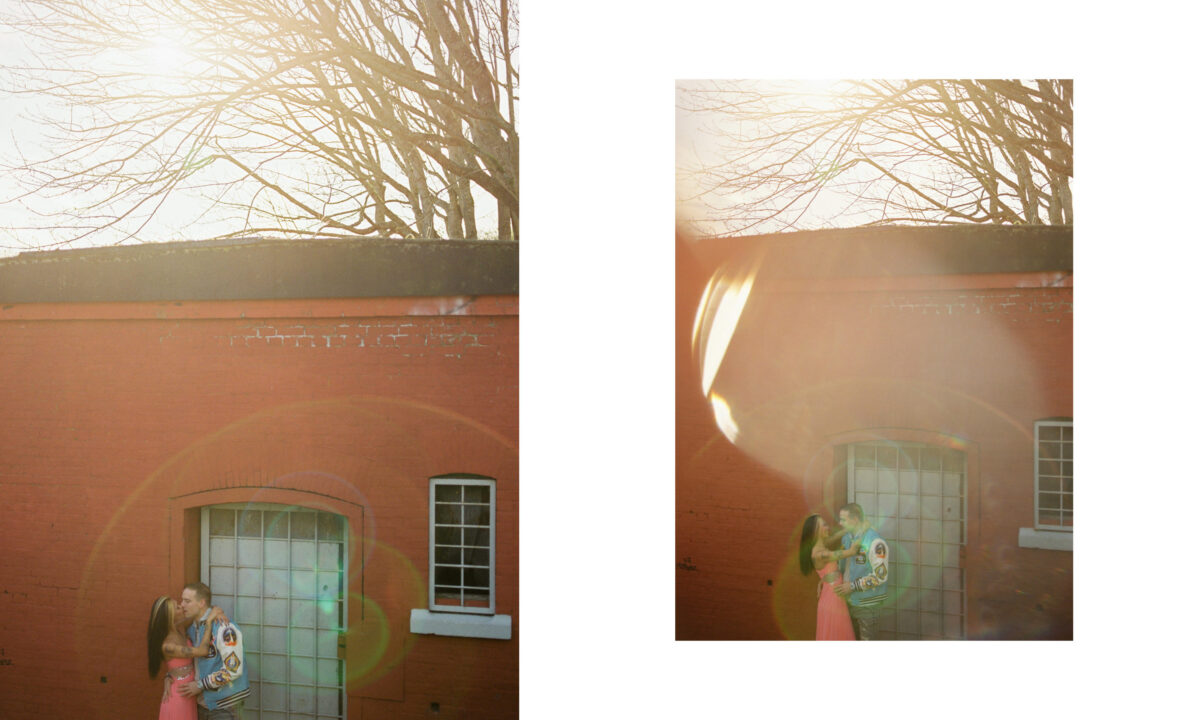 Creative portraits with sun flare of a couple against a red brick wall in Victoria British Columbia. 