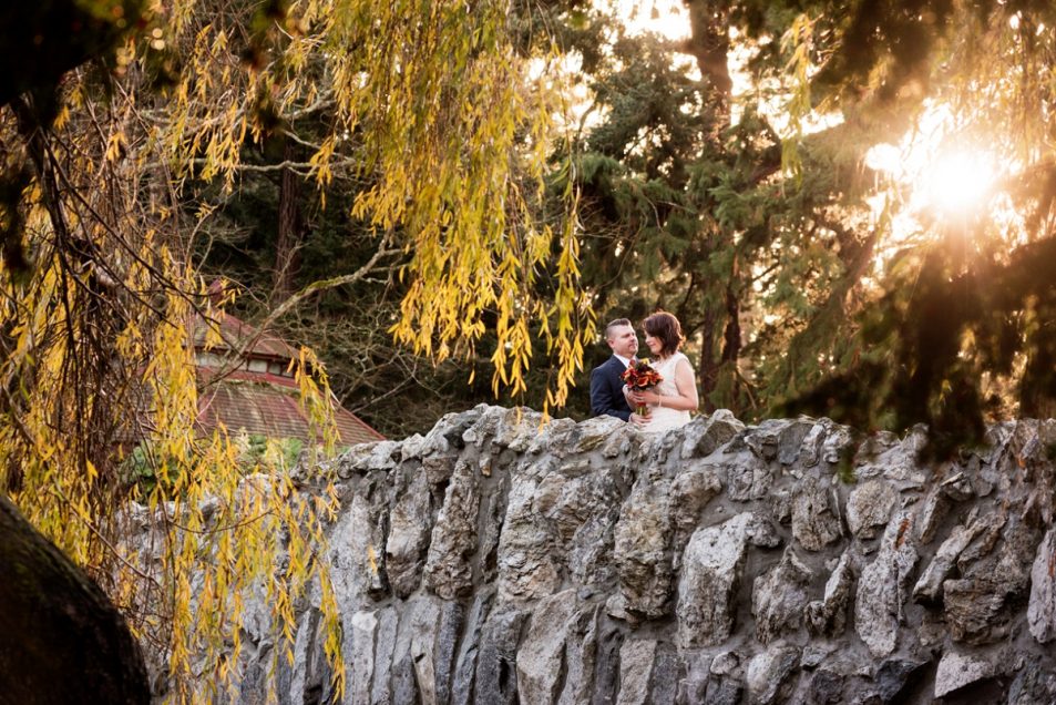 Beacon Hill Park Pop-up Wedding - a couple has their elopement portraits on the rock bridge overlooking the lake.