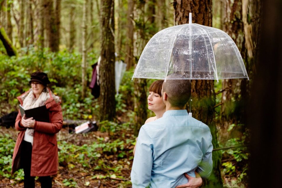 Rainy day wedding photography Victoria BC with clear umbrellas