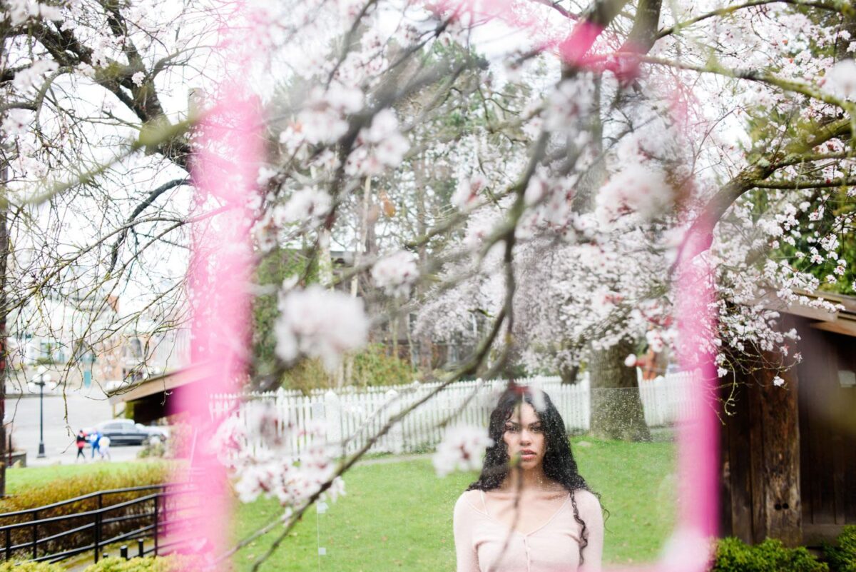 Artistic bespoke art portrait of a woman wearing pink in the cherry blossoms in Victoria BC