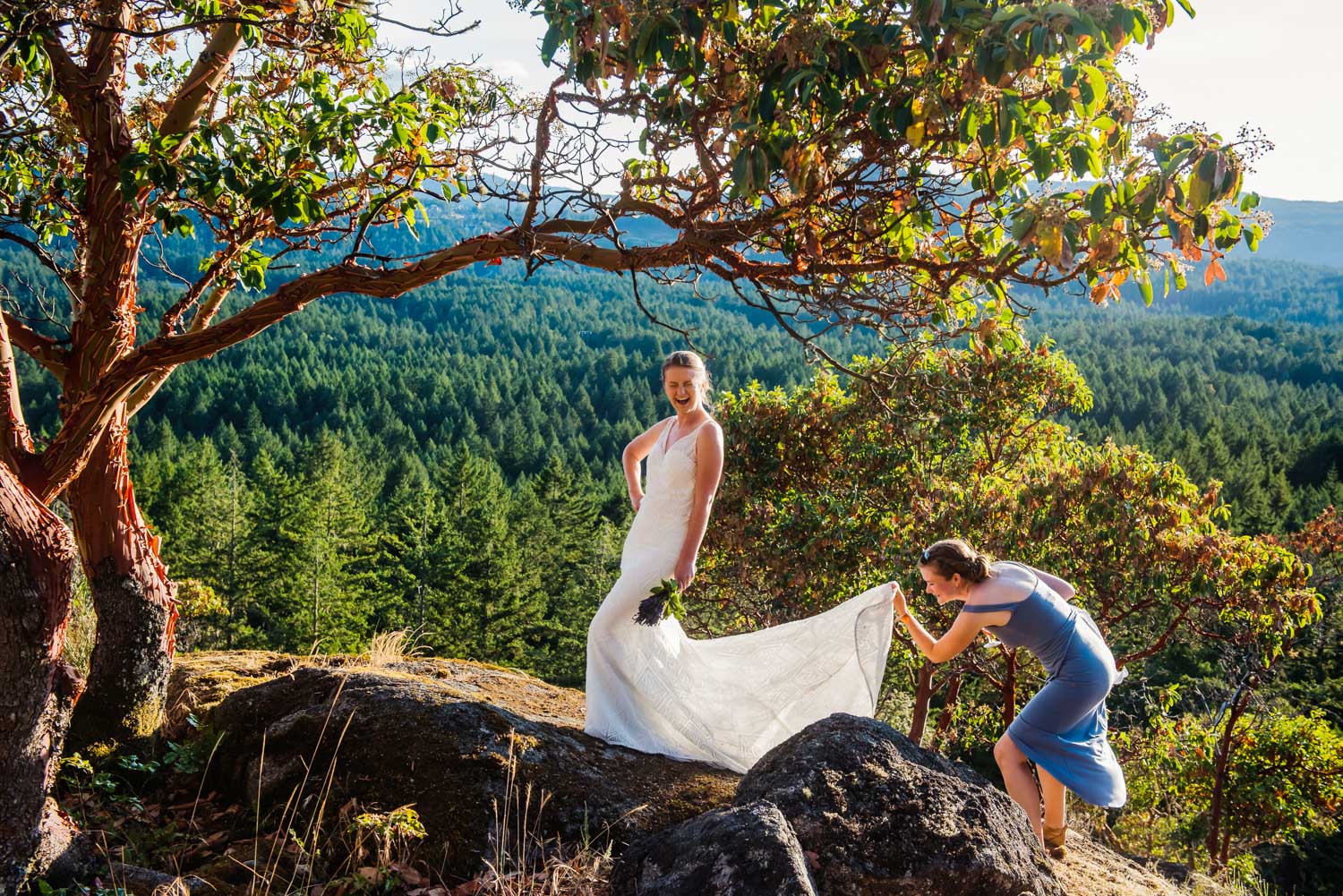Funny wedding photo at the summit of a hill at sunset in Victoria.