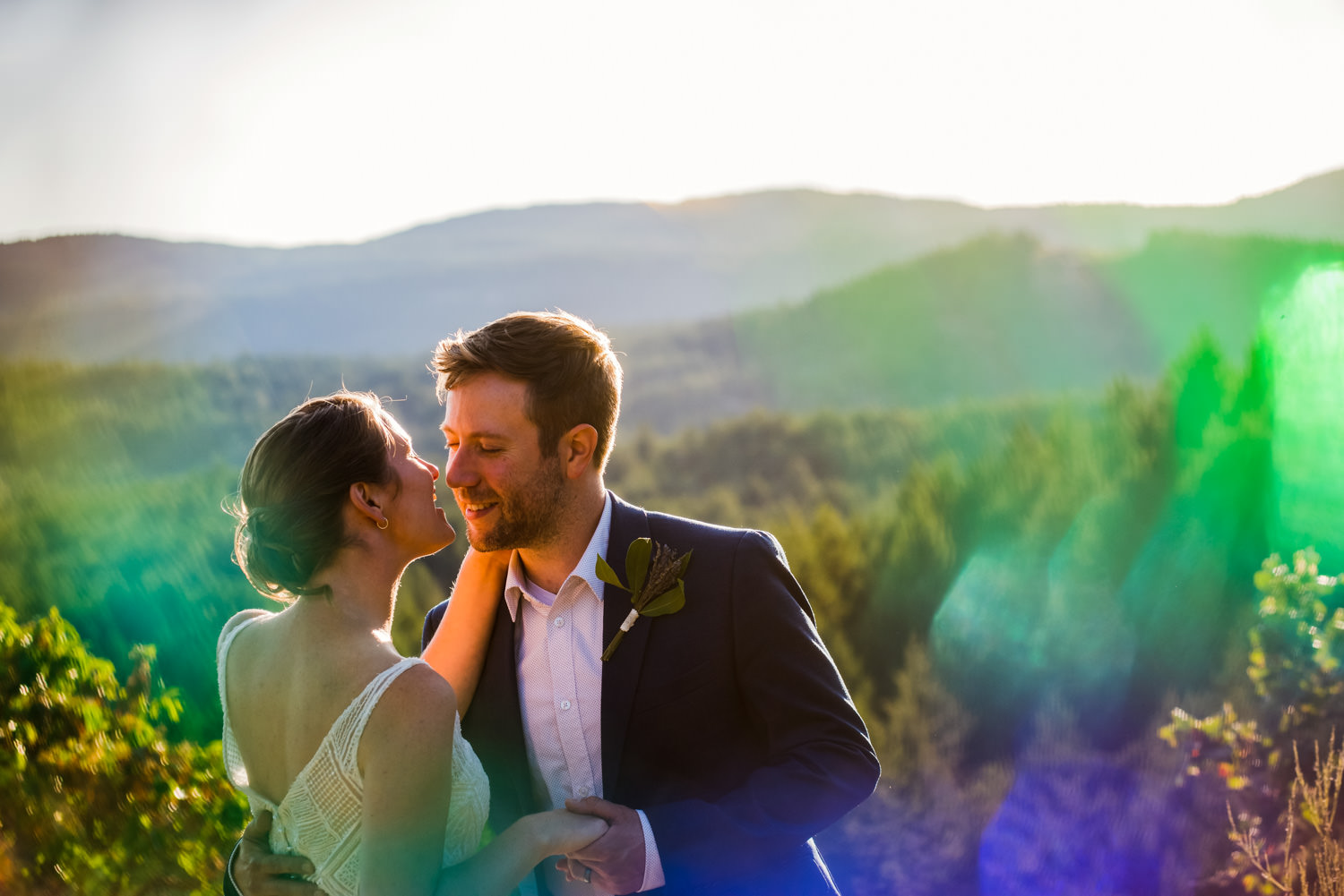 A portrait of a bride and groom at Thetis Lake Regional park at sunset