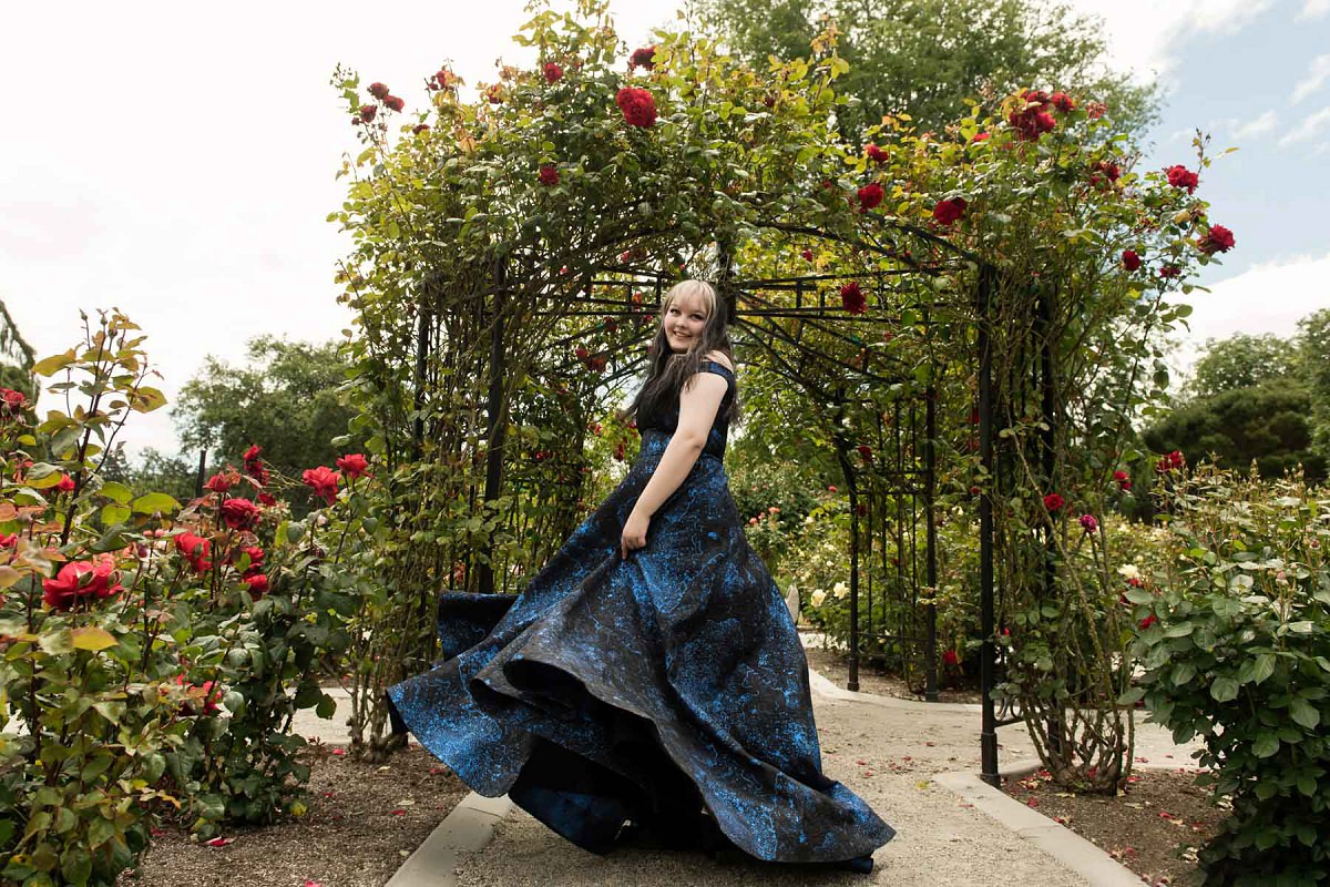 A Victoria BC graduation portrait of a high school student twirling in her prom dress at beacon hill park. This is a fashion editorial style grad photo.