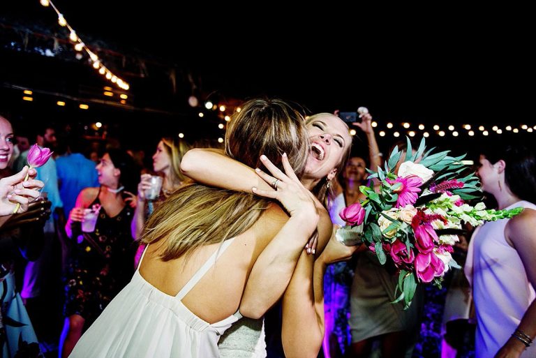 A wedding reception in Costa Rica at Langosta Beach Club. The bride celebrates on the dance floor with a friend.