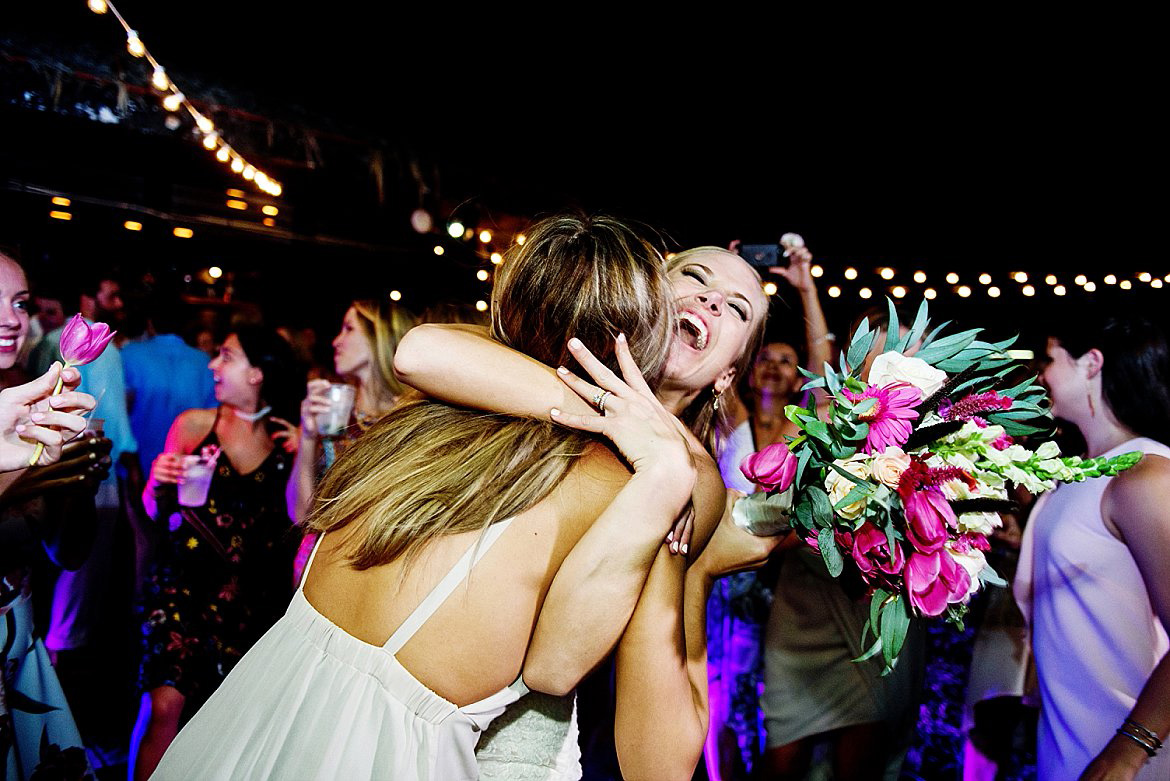 A wedding reception in Costa Rica at Langosta Beach Club. The bride celebrates on the dance floor with a friend.