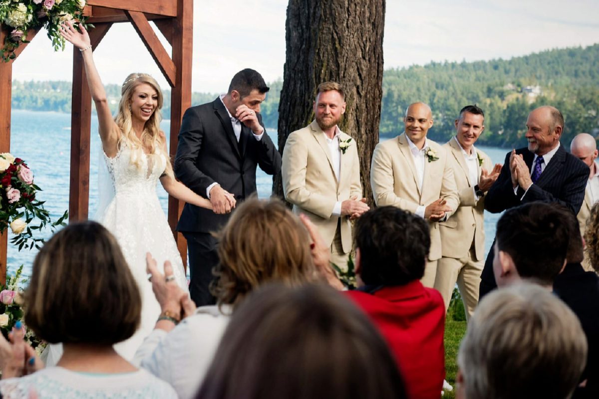 A couple walks down the aisle at their Beach Club wedding in Victoria BC