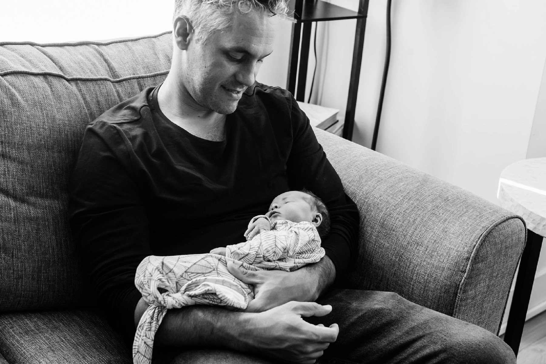 Dad holding a newborn baby during a newborn portrait session in Victoria BC