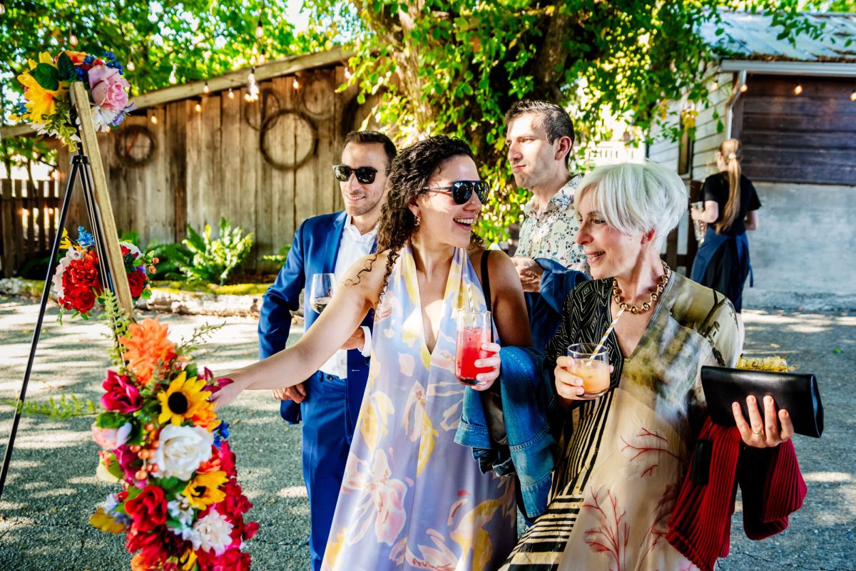 Guests shown wearing colourful outfits at a wedding