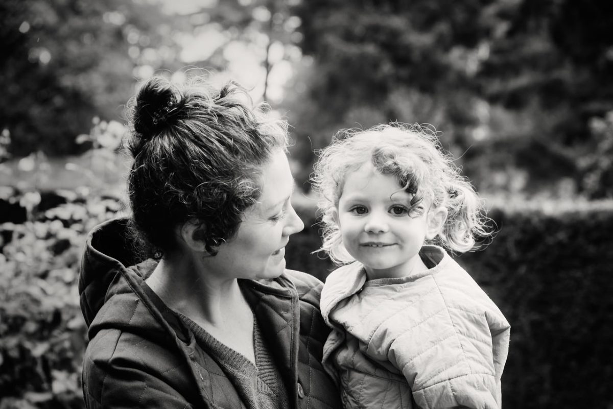 A mommy and me natural candid portrait with a toddler in black and white