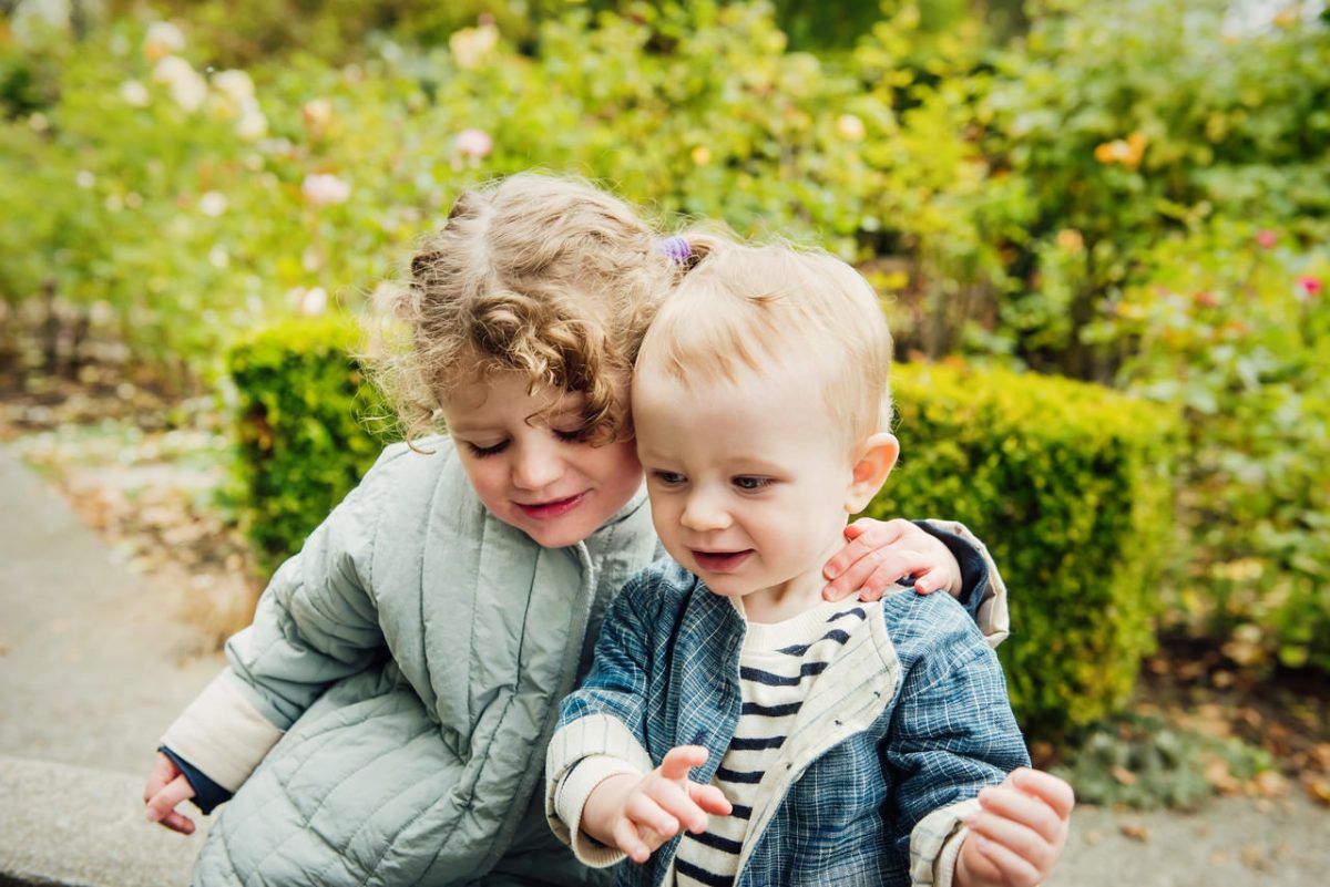 A candid portrait of a brother and sister cuddling during a fall mini session in Victoria BC