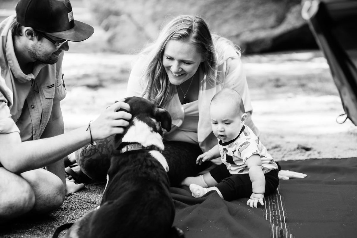 Baby and dog on a deserted beach in British Columbia