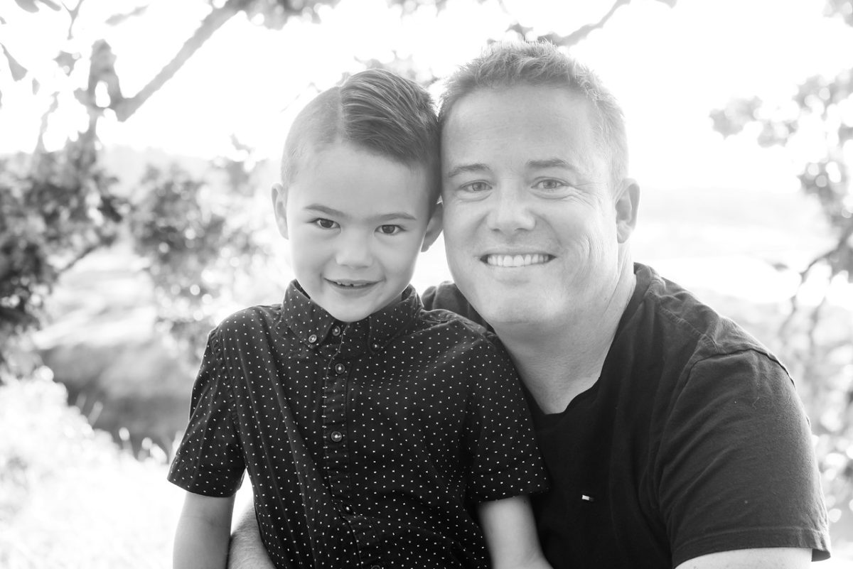 Father son family portrait in black and white photographed in a candid and natural way