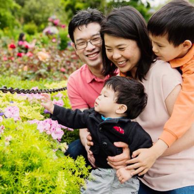 A family of four enjoying a portrait session at Butchart Gardens in Brentwood Bay Victoria BC