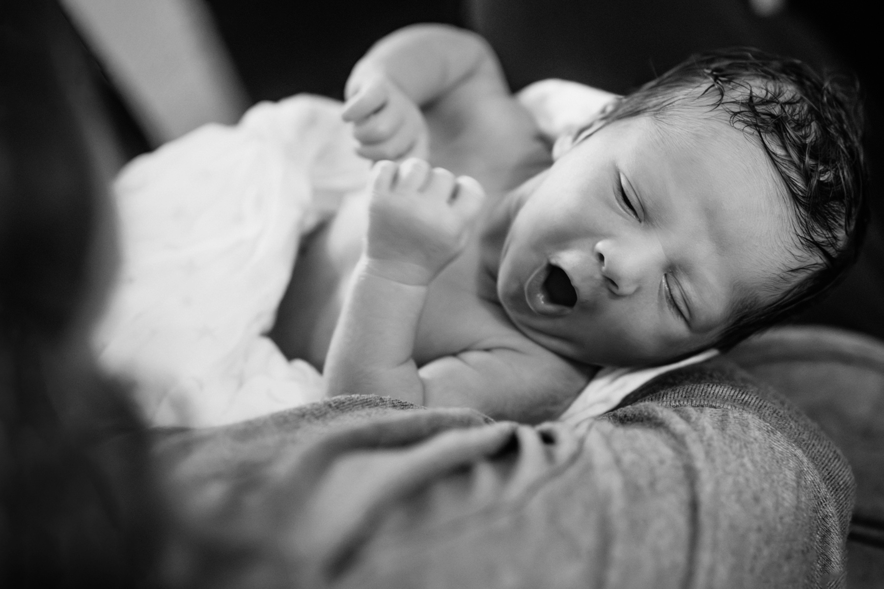 A 10-day old newborn portrait in black and white of a baby making a cute face in Victoria BC