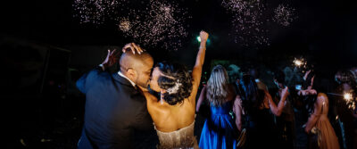 A couple kisses on their wedding day in Victoria BC while watching fireworks.