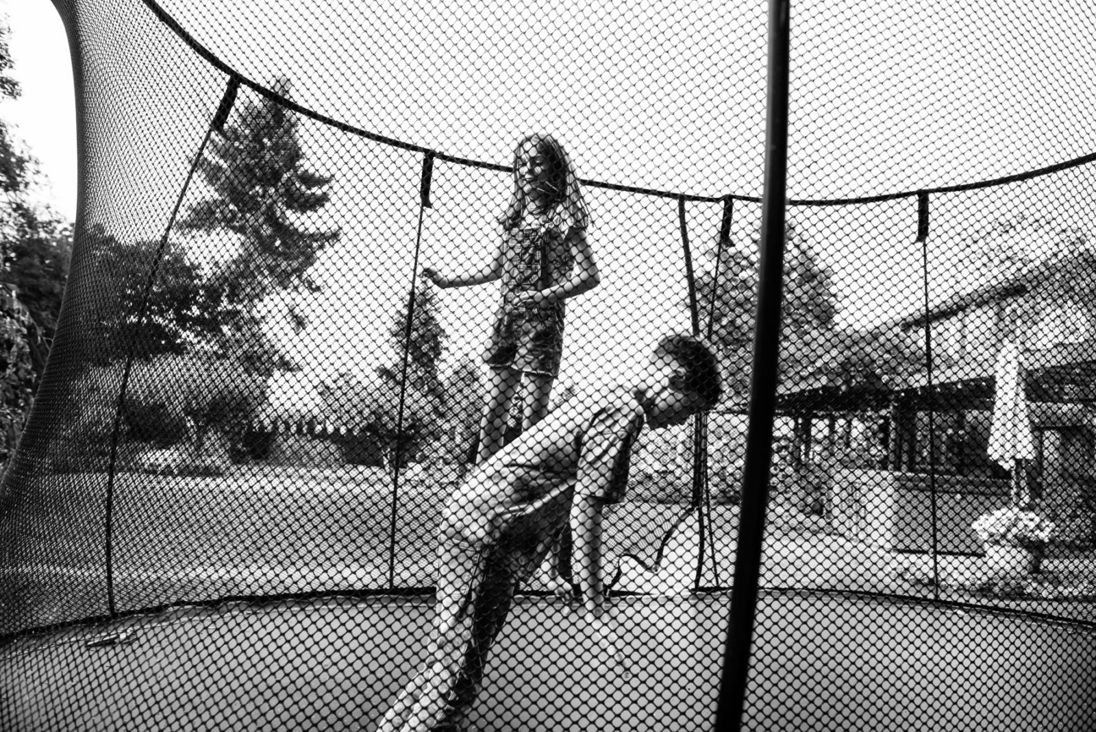 Kids playing on a trampoline in their backyard in Victoria BC