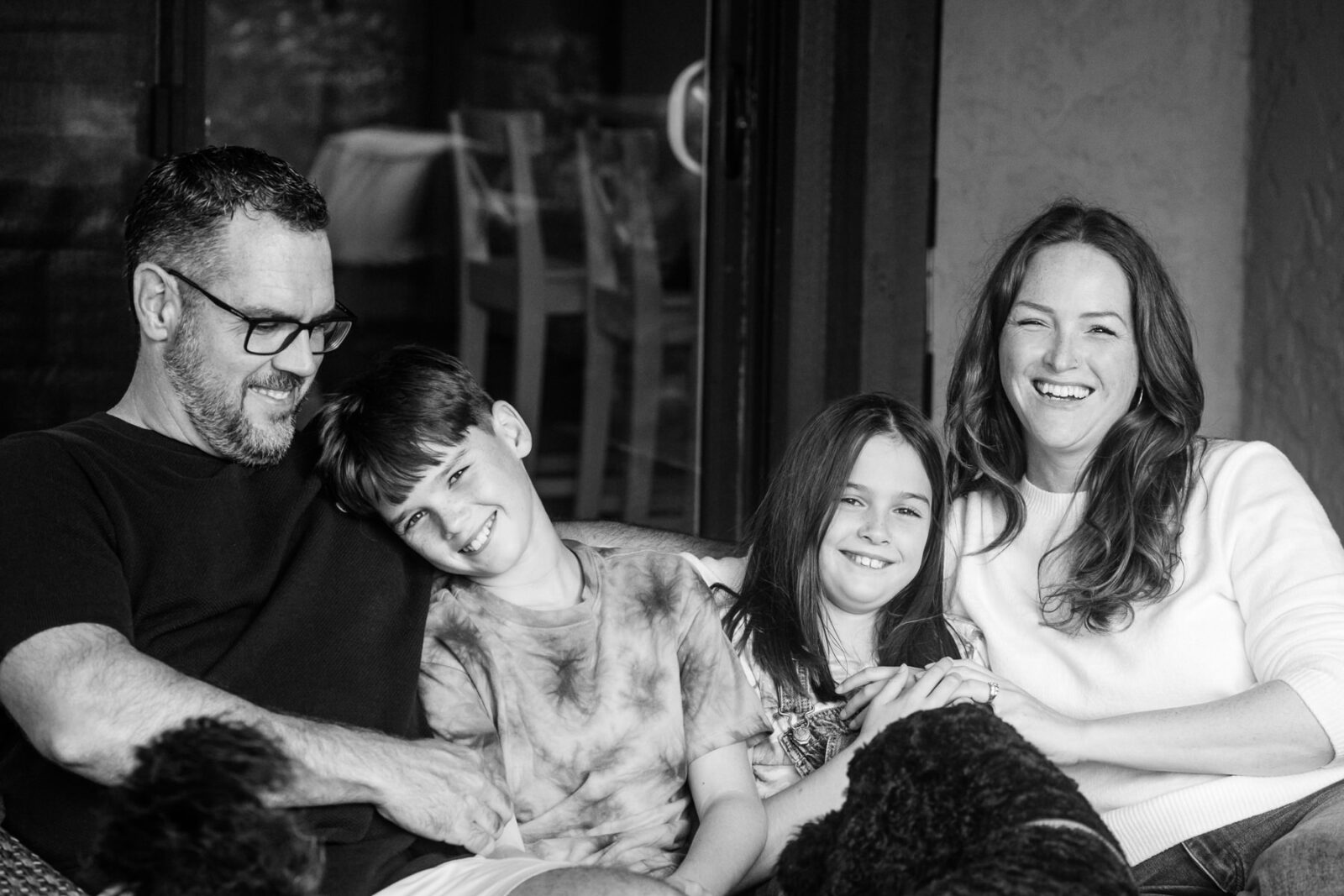 Casual family portrait of a family of four with adolescent kids.