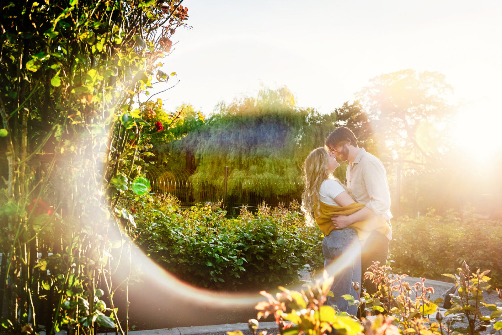 An artistic abstract couples' engagement portrait in the gardens on a summer day in Beacon Hill Park, Victoria BC