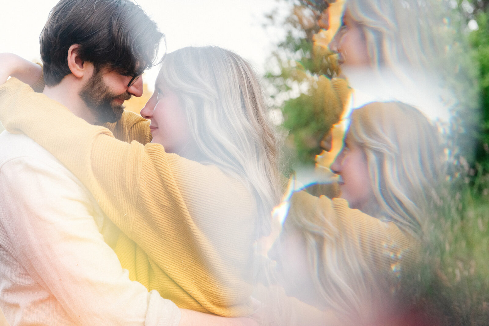 A couple looks at each other in a prismatic special effect portrait taken in Victoria BC