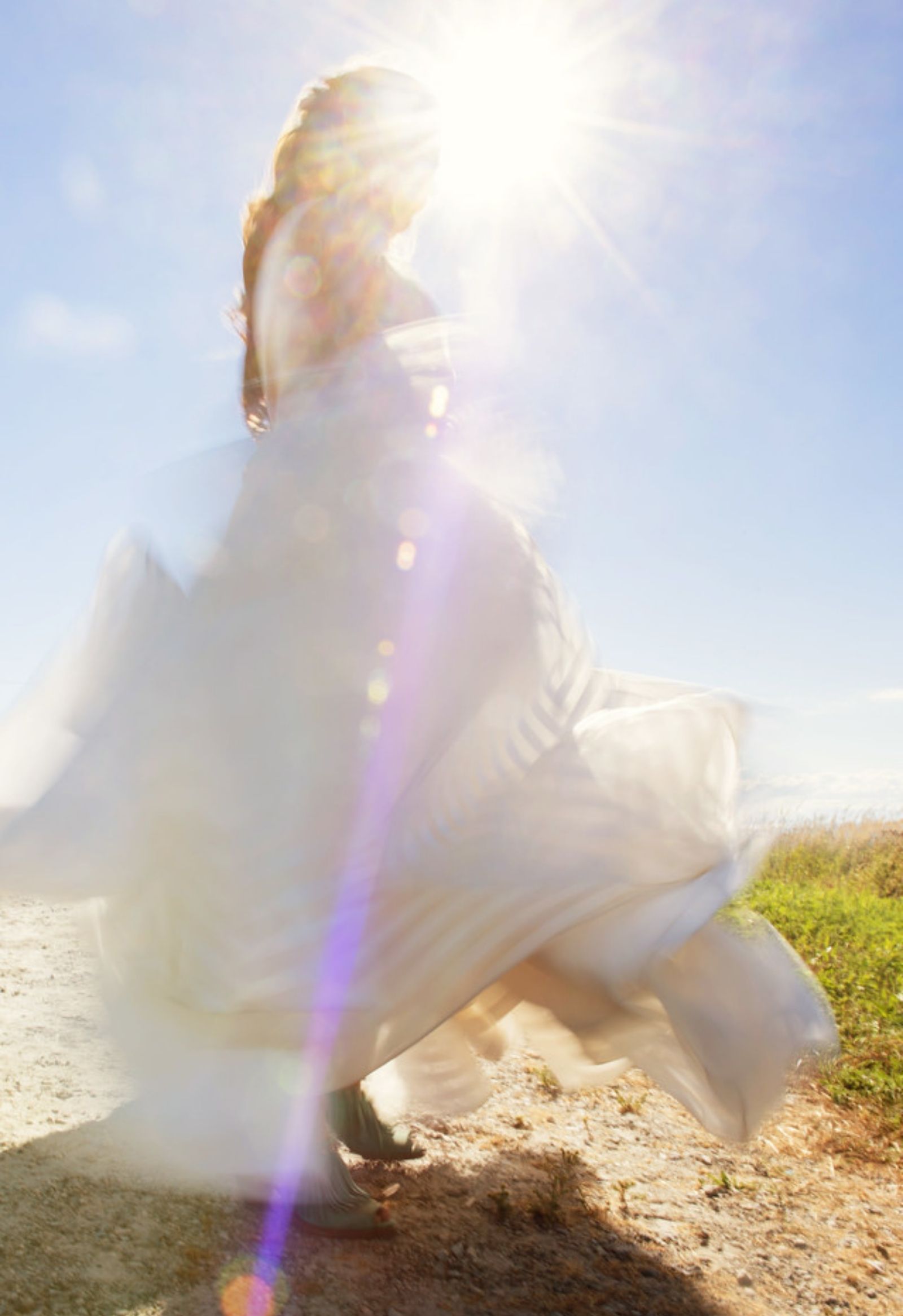 A creative blur photo on film of a bride twirling on the camera with motion blur