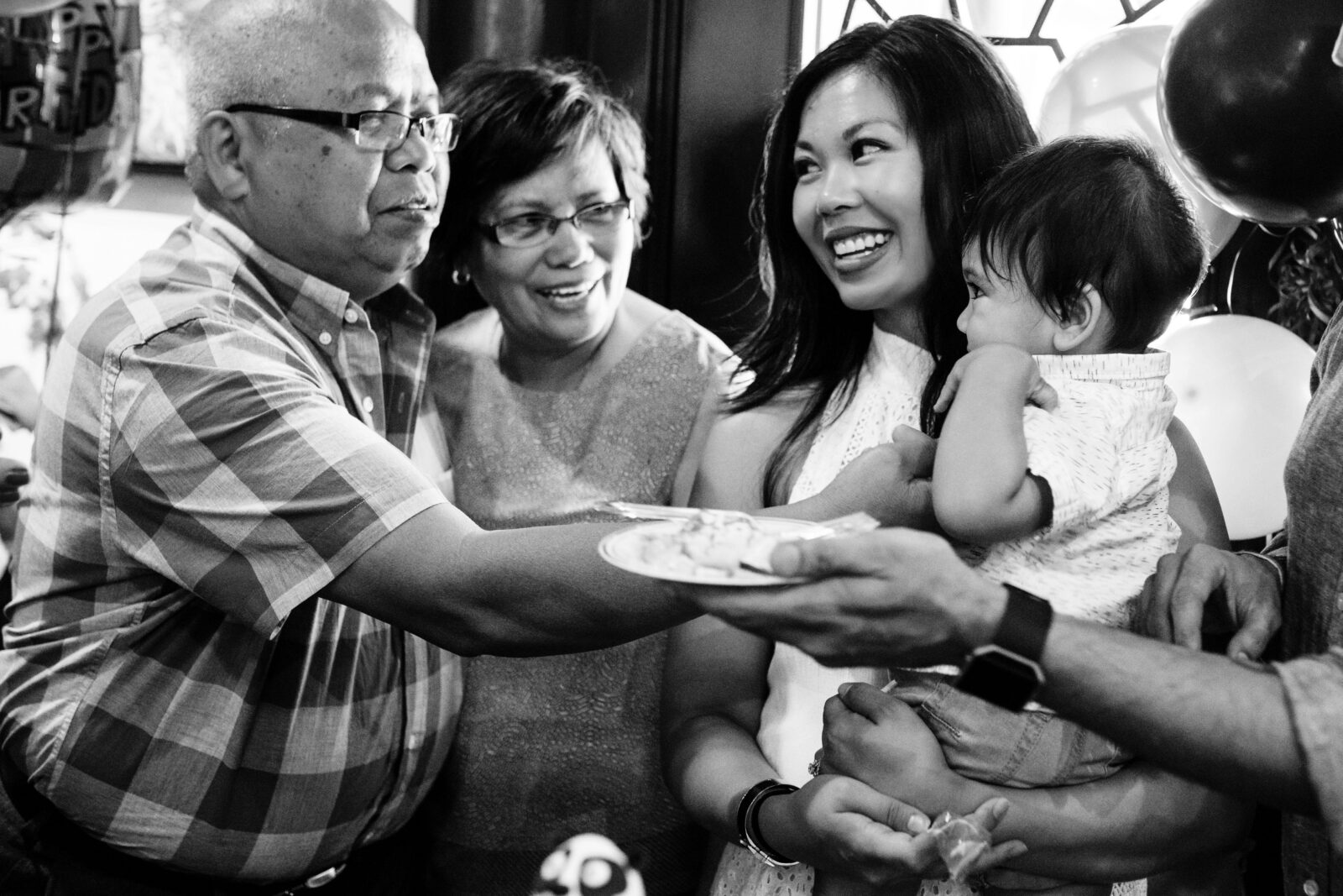 A cute family photo of a baby on his first birthday at Dr. Sun Yat-Sen Classical Chinese Garden in Vancouver BC