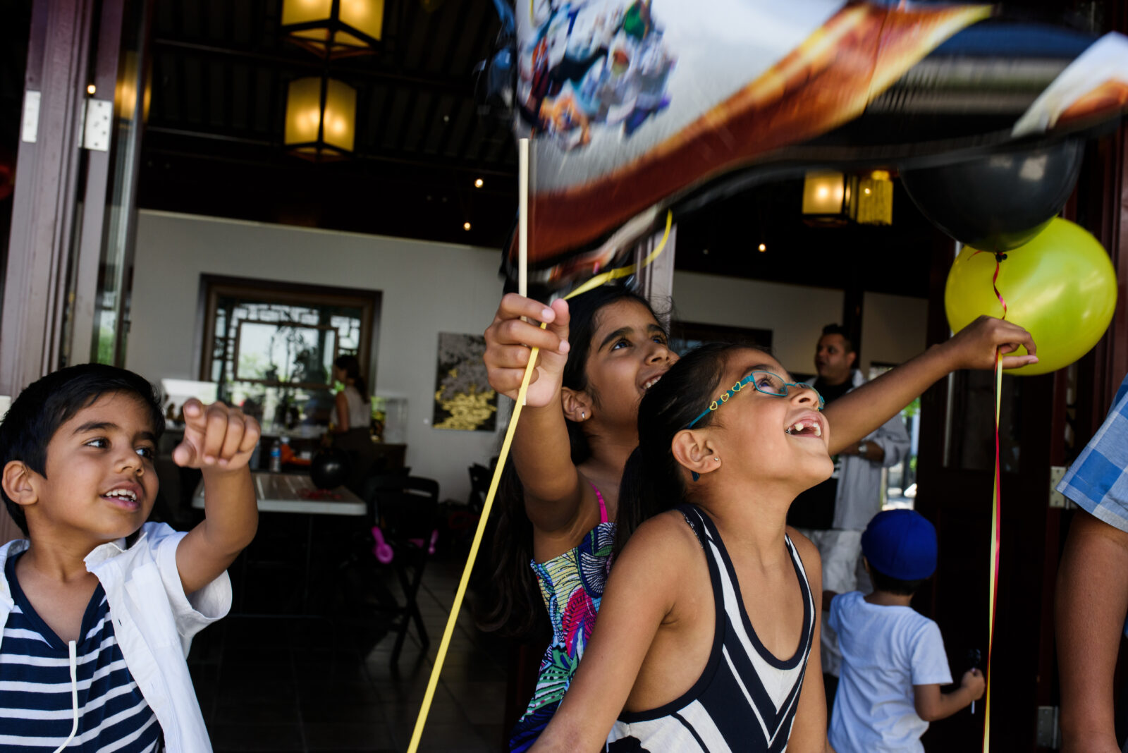 Kids at a birthday party playing with baloons