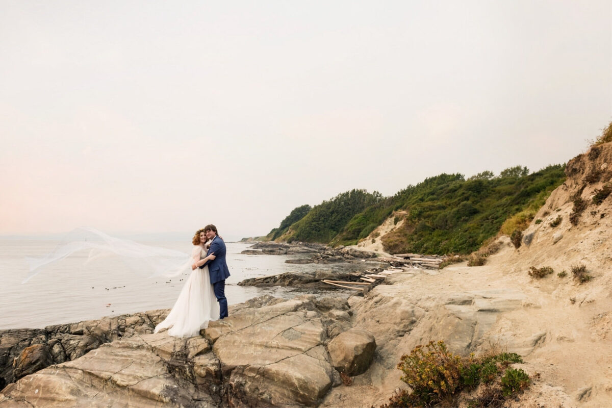 Victoria BC wedding portrait of a bride and groom at the rocky shore of the ocean at Dallas Road