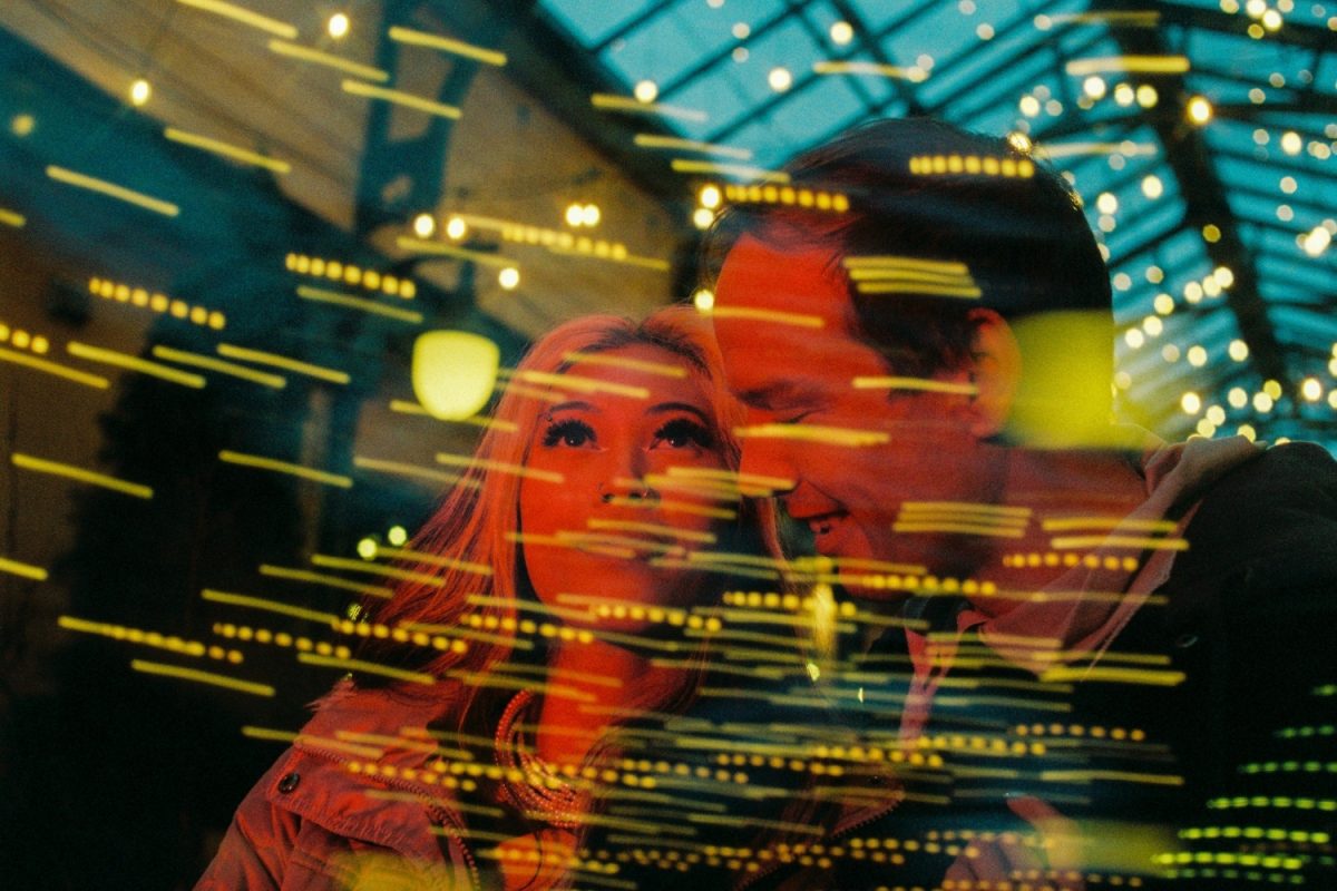 A double exposure 10th anniversary portrait of a couple at night in an alley in Sidney BC near Victoria shot on Kodak 35mm film.