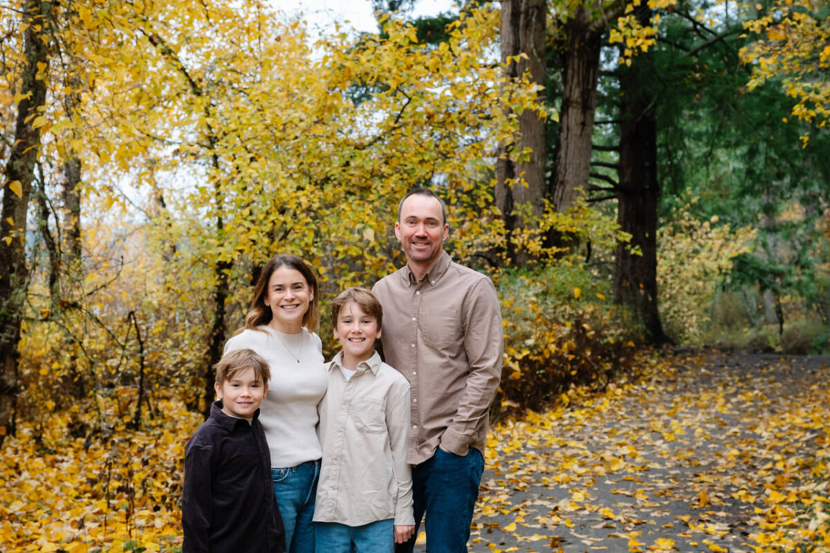 Casual and relaxed Victoria BC family portrait of a family of four surrounded by fall leaves at Elk Lake