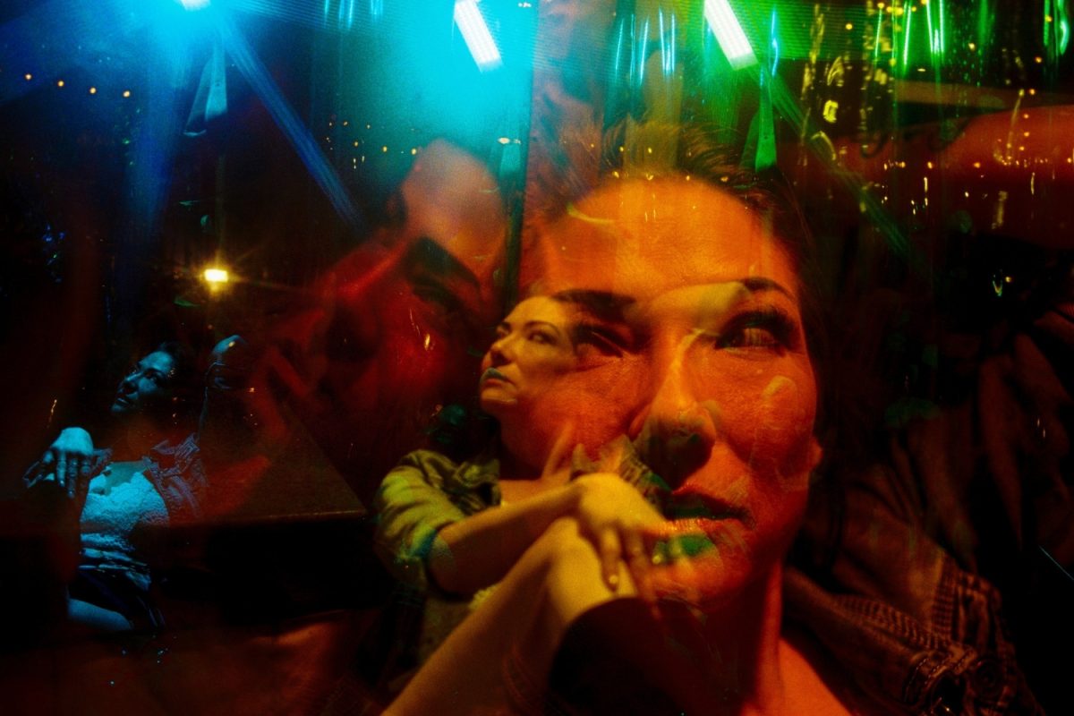A triple exposure on Kodak Ultramax. The closeup of Britt also has a reflection from the vinyl wall enclosing the restaurant. I waited for the restaurant lights to change from blue to orange to red and zoomed in and out for each click