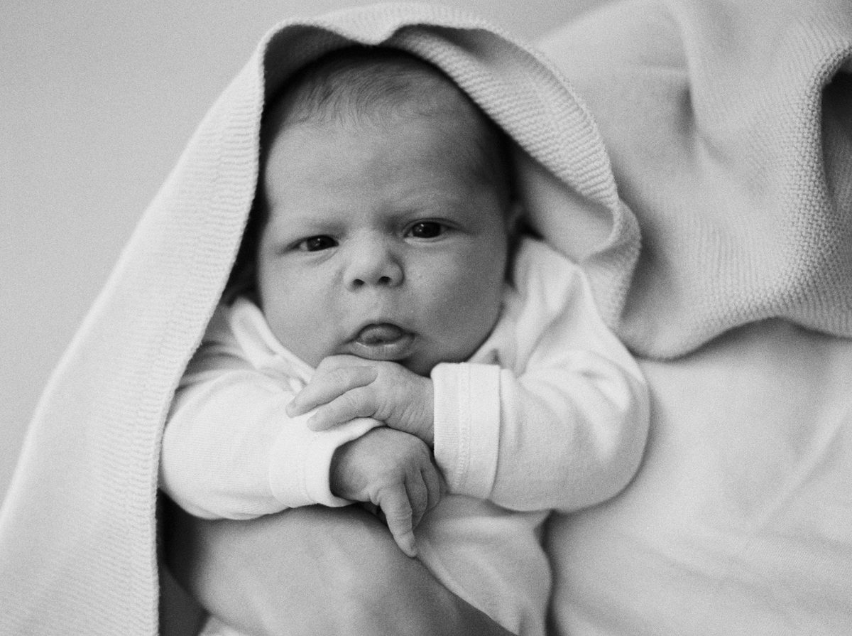 An analog film photo of a newborn baby in Victoria BC taken with Delta 3600 film.
