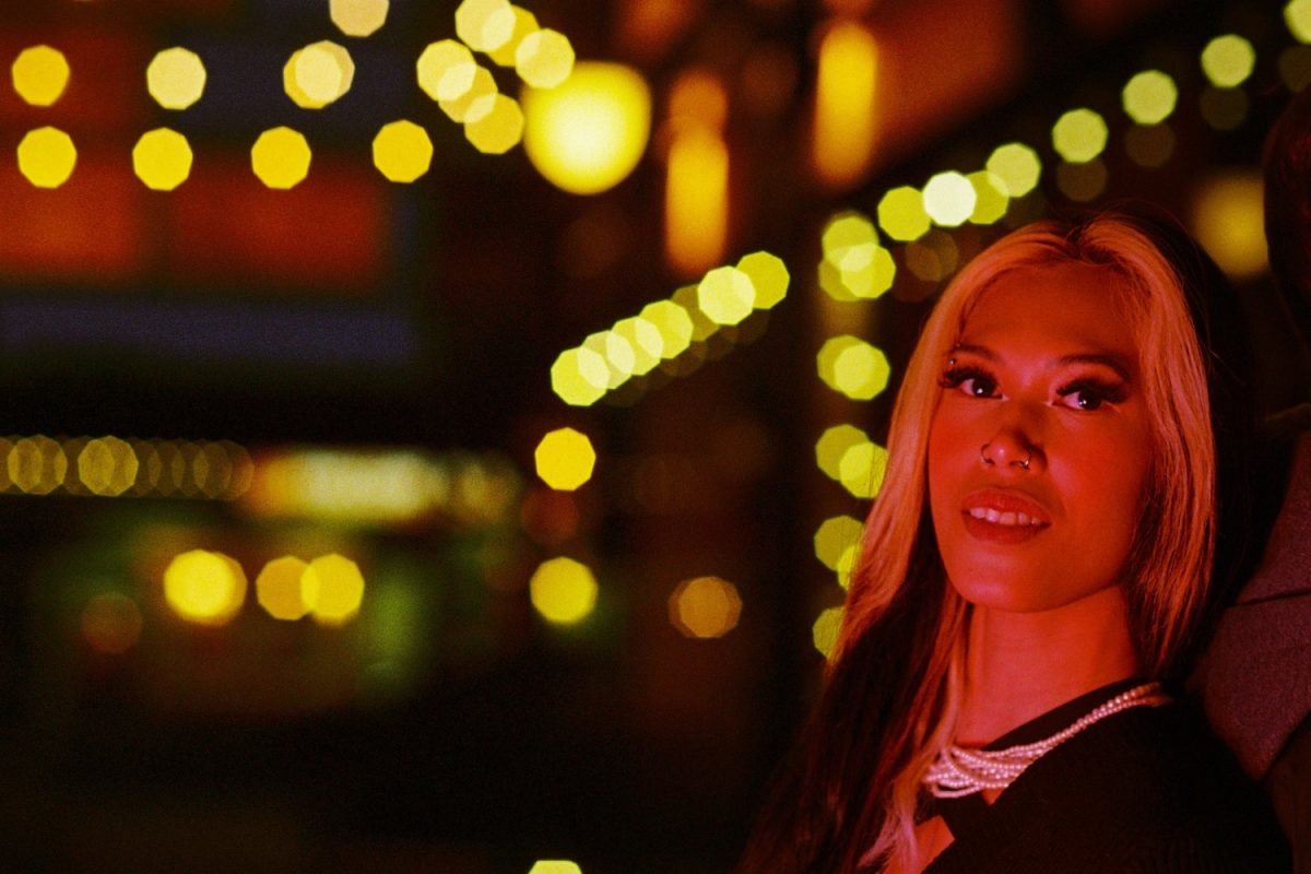 A fashion model photo shoot at night using Kodak Ultramax 400 35mm film scanned and developed by the Canadian Film Lab. A red light illuminates the model