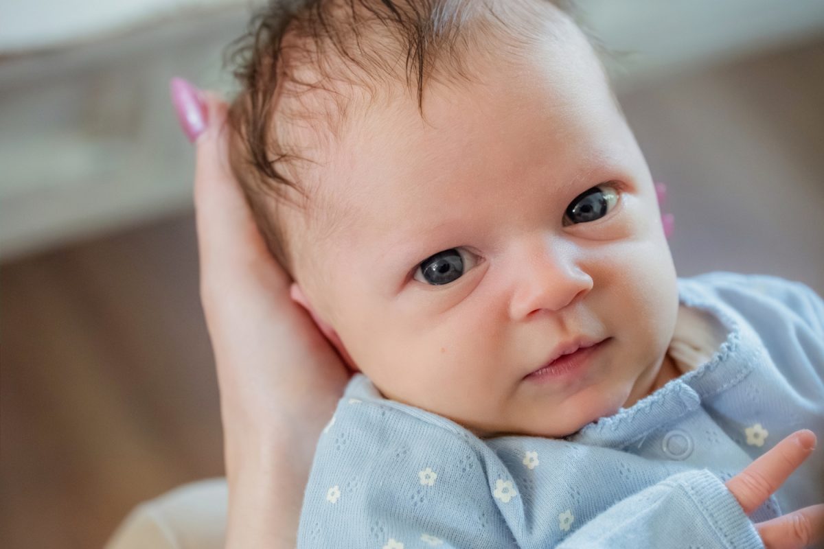 A cute newborn portrait of a baby looking at the camera in Victoria BC.