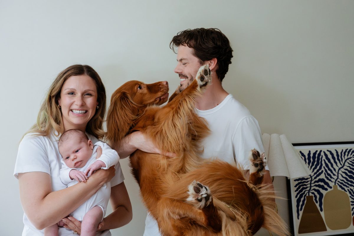 A family photo with a dog and a newborn in colour in the family's house in Victoria BC