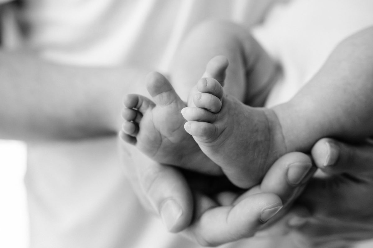 Closeup newborn photo of baby's feet and toes.